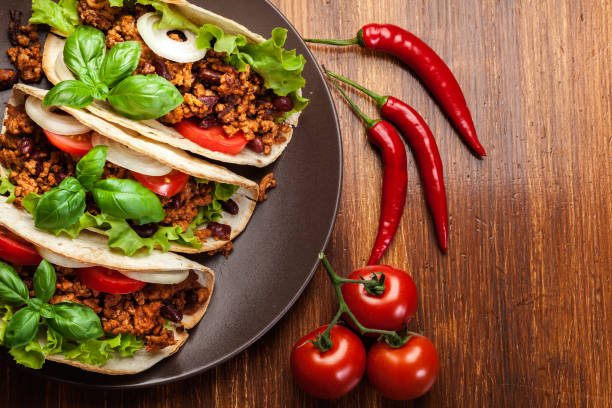 Mexican tacos with minced meat, beans and spices stock photo