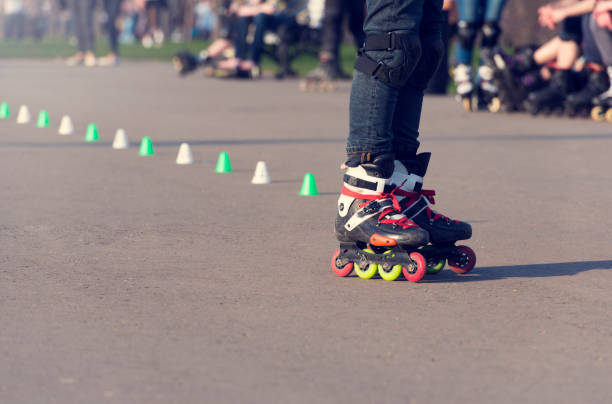istock Legs of a roller skating man in a park 675933828