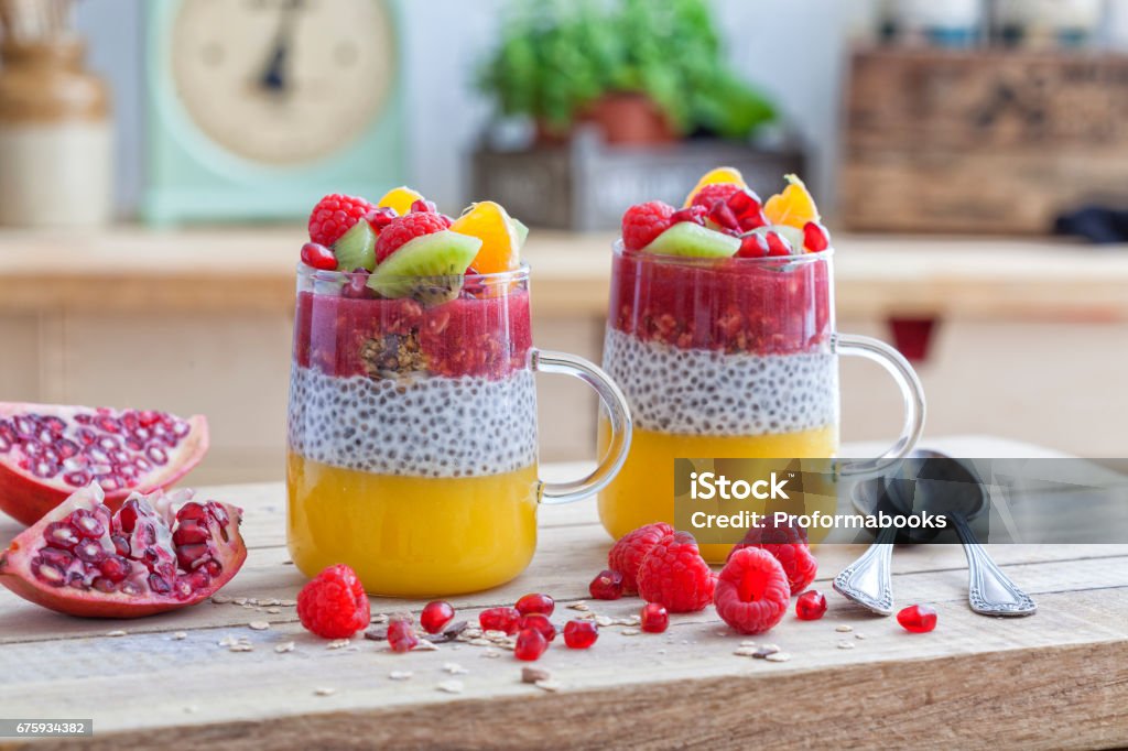 Healthy dessert in a glass with chia seeds Healthy dessert in a glass with chia seeds, mango, cereals, raspberry and kiwi. Smoothie Stock Photo