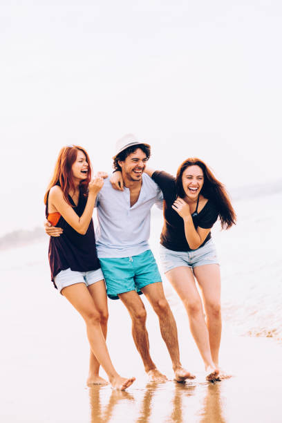 istock Friends taking a walk on the beach 675934424