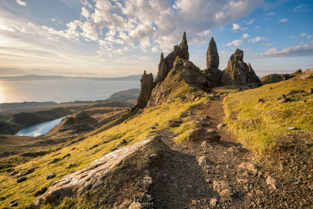Isle of Skye, Scotland. The Old Man of Storr at sunrise Sunrise at the Old Man of Storr, Isle of Skye, Scotland. Close look at the massive pinnacle of the Old Man of Storr - one of Scotland's most iconic places. The Old Man is in fact just one element in an array of fantastic rock features, and the views out over the Sound of Raasay and to the mainland are stunning. The Storr (Scottish Gaelic: An Stòr) is a rocky hill on the Trotternish peninsula of the Isle of Skye in Scotland. The hill presents a steep rocky eastern face overlooking the Sound of Raasay, contrasting with gentler grassy slopes to the west. isle of skye stock pictures, royalty-free photos & images