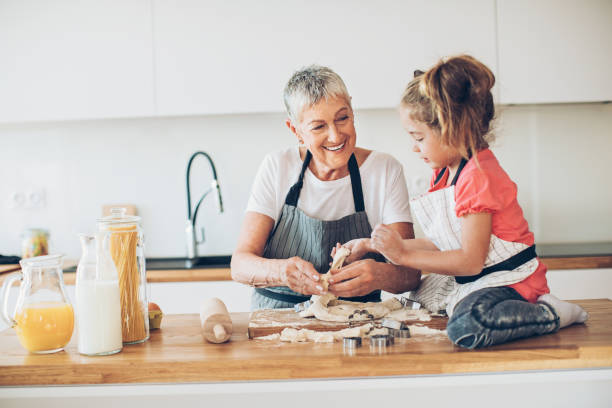 istock Granny, let me help you with the cookies! 675941106