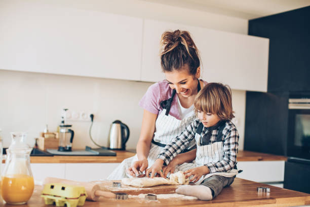 Mother and son making cookies together