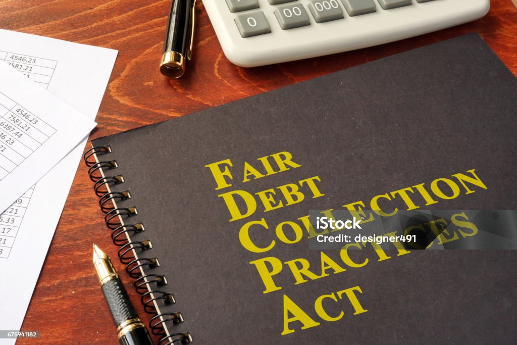 FDCPA Fair Debt Collection Practices Act on a table. Collection Stock Photo