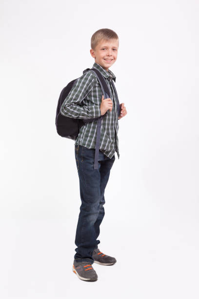istock beautiful student with a backpack on his shoulders standing on white background and smiling 675942836