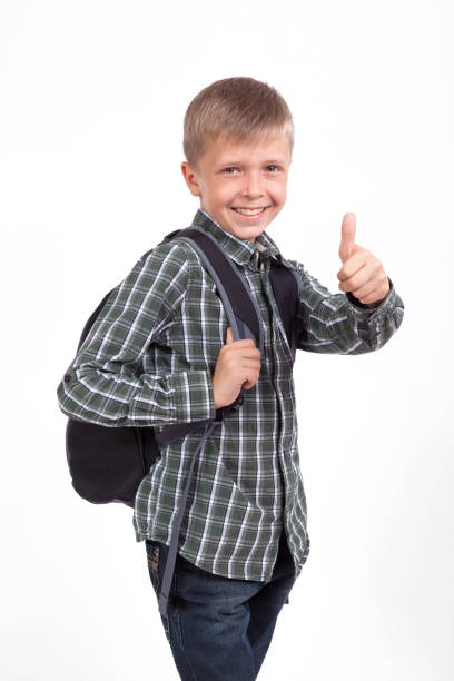 istock beautiful student with a backpack on his shoulders standing on white background with a smile, looking into the camera, picture with depth of field 675942848