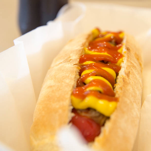 istock Grilled Hot Dog on wood background 675947282