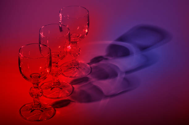 Row of empty wineglasses with color shadows.