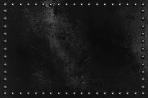 istock Black metal plate texture with rivet. 675952576