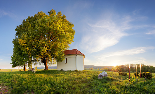 Lonely chapel in farm fields in spring day
