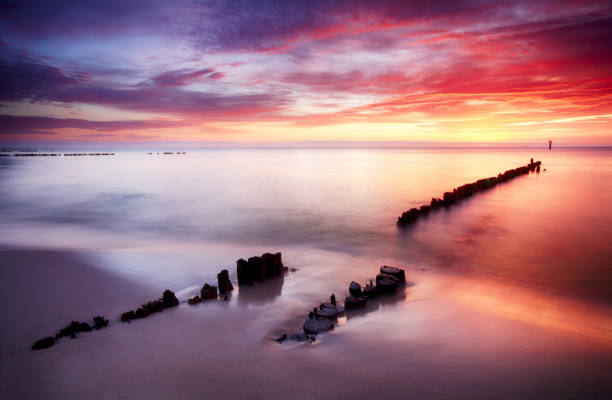 istock Beautiful colored clouds over the ocean at the beach at sunset 675956108