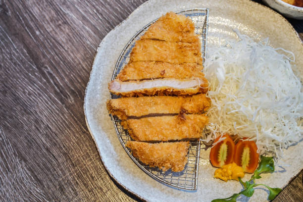 istock Japanese deep-fried breaded pork cutlet or Tonkatsu with sliced cabbage , tomato and custard 675962474