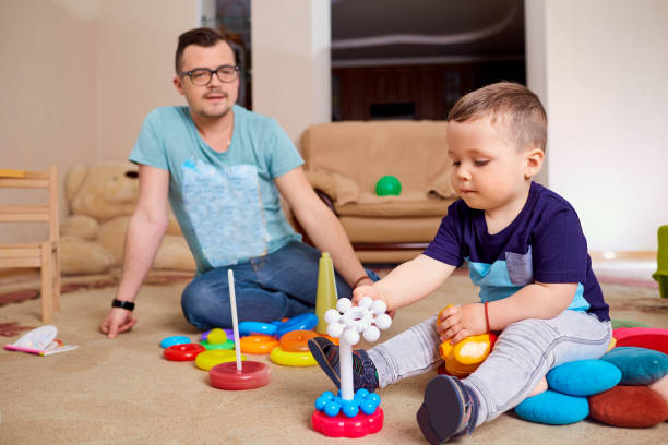 istock Dad and son are playing on the floor in  room. 675971866