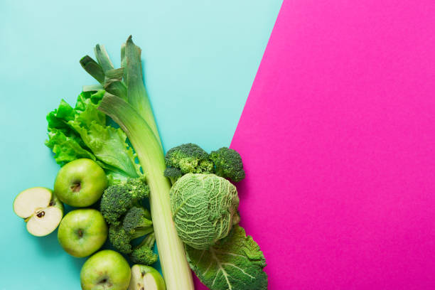 istock Flat lay of green vegetables on bright background 675975746