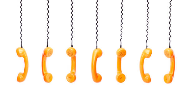 istock Handset piece from an old phone suspended by phone cord 675979072