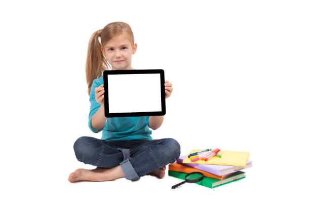 istock school girl with a tablet in hands looking at the camera and smiling 675979312