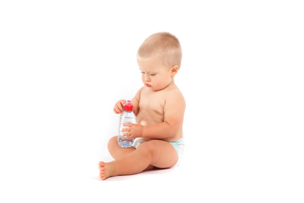 istock cute boy in diapers with water bottle 675987224