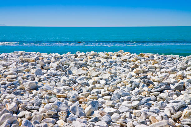 White and gray stones softly rounded against a blue sky