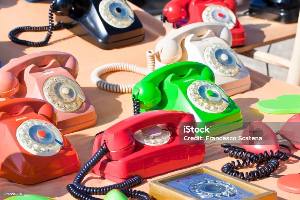 Old colored plastic analog phone in a flea market Flea Market Stock Photo