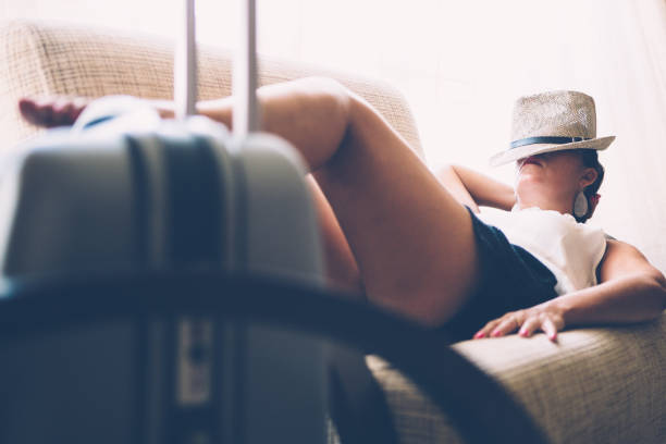 istock Female sleeping in airport hall 675993458