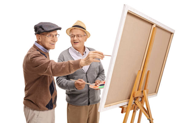 istock Two happy mature men painting on a canvas 675993610