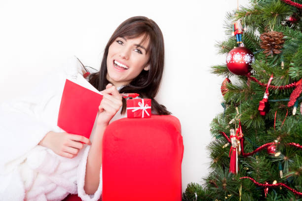 istock Happy woman writing Christmas greeting card 675993796