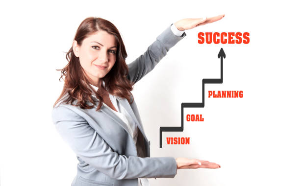 A business woman who fear formalwear showing success chart between her hands