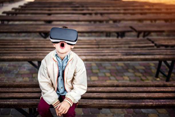 istock Little boy in virtual reality glasses outdoor 676000246