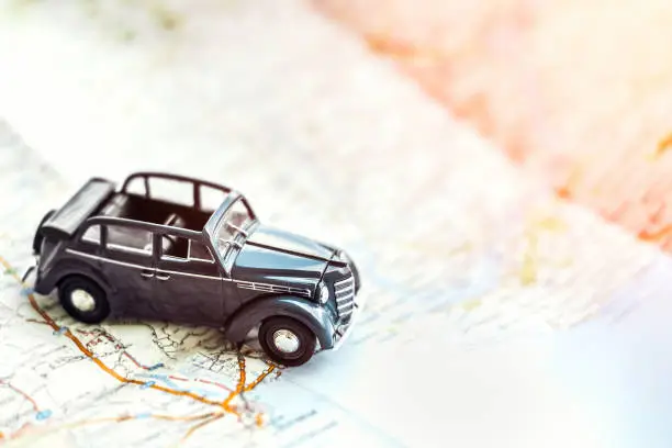 retro cabrio car on the map, tourism concept