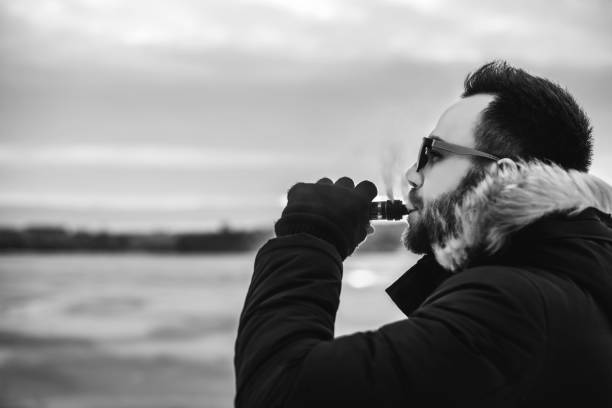 istock Man smoke electronic cigarette outdoor 676004568