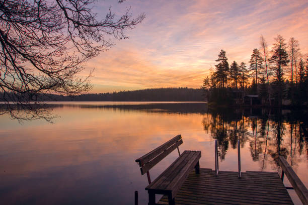 istock Nature evening sunset over a lake. Beautiful trees reflected in the water. 676008230