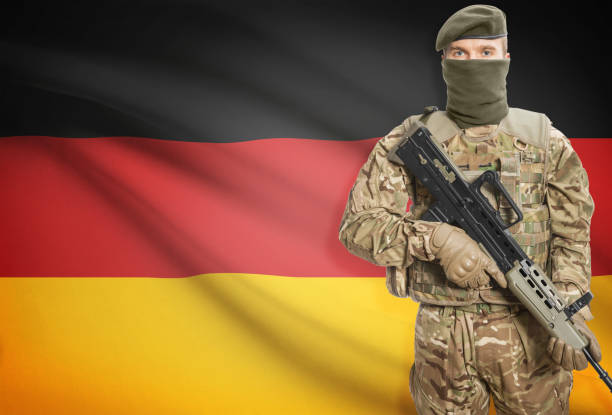 istock Soldier holding machine gun with flag on background series - Germany 676008252