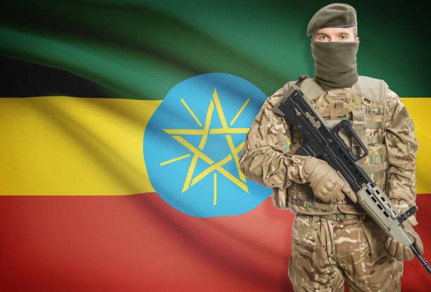 istock Soldier holding machine gun with flag on background series - Ethiopia 676008458
