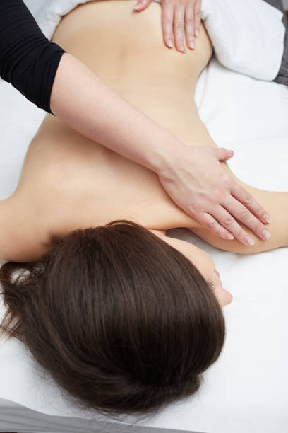 istock Beautiful woman having relaxing massage  in spa salon 676008880