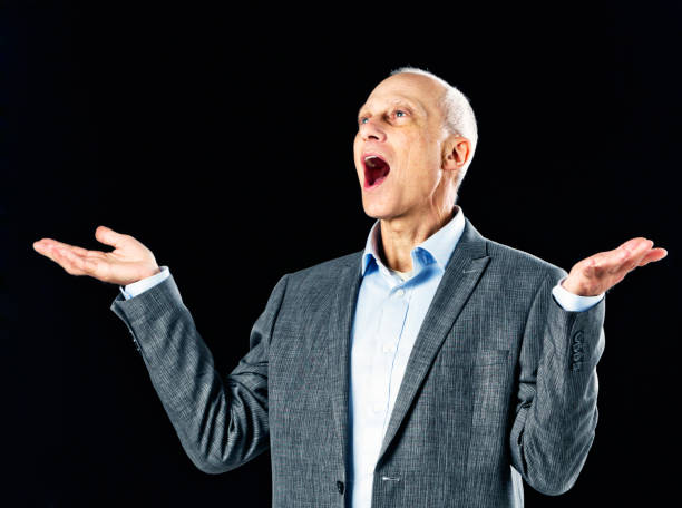 istock Mature businessman gestures as he speaks or sings 676011832