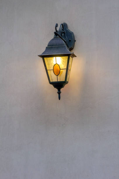 istock Old street lamp on the wall shines 676012396