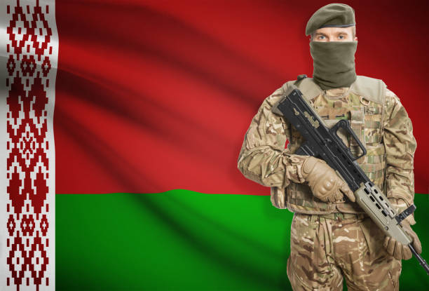 istock Soldier holding machine gun with flag on background series - Belarus 676016230