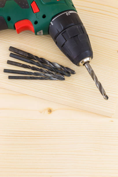 istock Still Life of Electrical Drill with Drill Bits arranged on a wooden background. 676018496