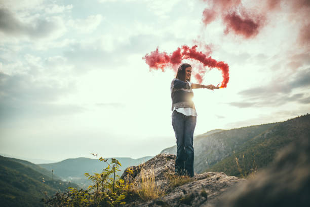 istock Girl with a red smoke 676019252