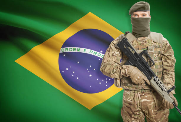 istock Soldier holding machine gun with flag on background series - Brazil 676019286