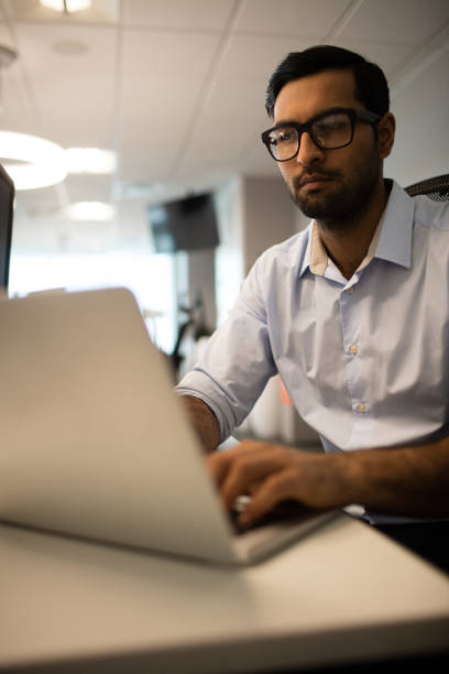istock Young businessman working on laptop in office 676019404