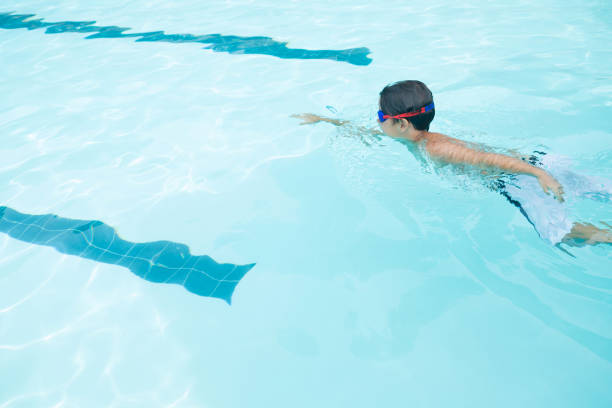 istock Boy swimming in the pool 676019444