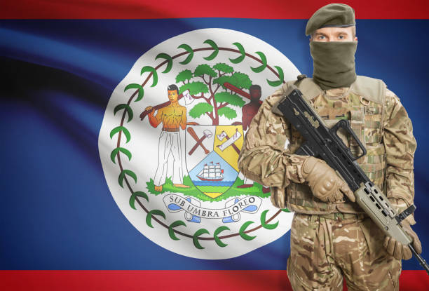 istock Soldier holding machine gun with flag on background series - Belize 676019884