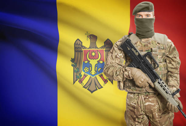 istock Soldier holding machine gun with flag on background series - Moldova 676022392