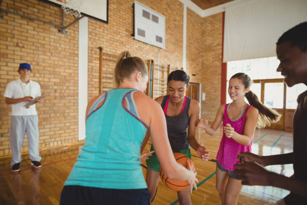 istock High school team playing basketball 676022586