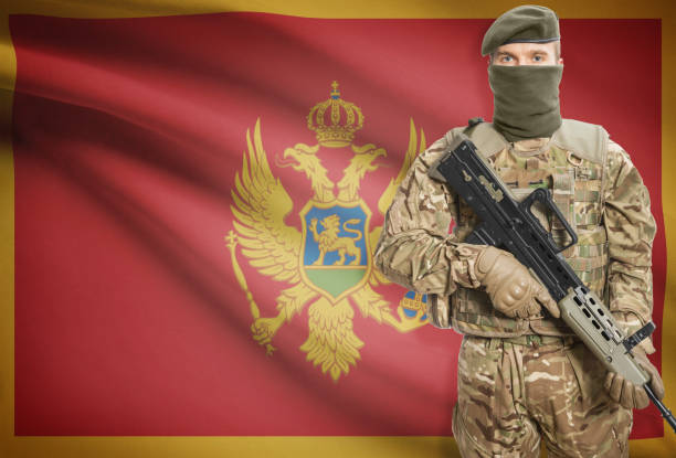 istock Soldier holding machine gun with flag on background series - Montenegro 676022740