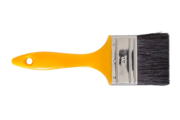 Yellow handled paintbrush cut out on a white background. Tools series.