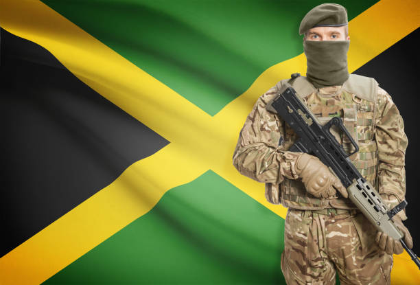 istock Soldier holding machine gun with flag on background series - Jamaica 676023328
