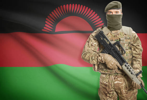 istock Soldier holding machine gun with flag on background series - Malawi 676030200