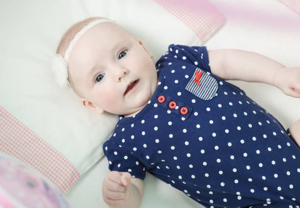 istock Infant lies on her back in a baby crib. 676031106